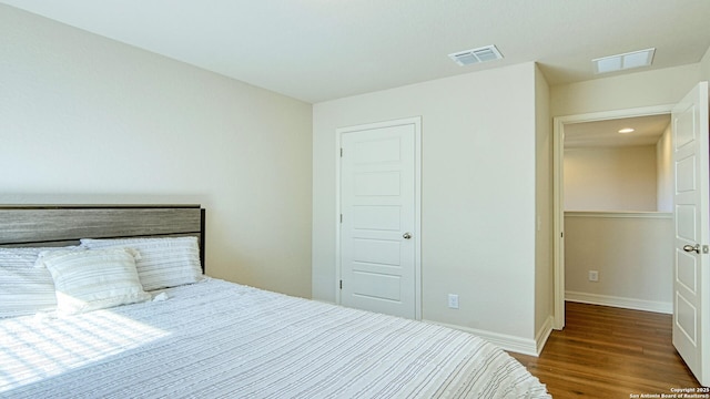 bedroom with a closet and dark wood-type flooring