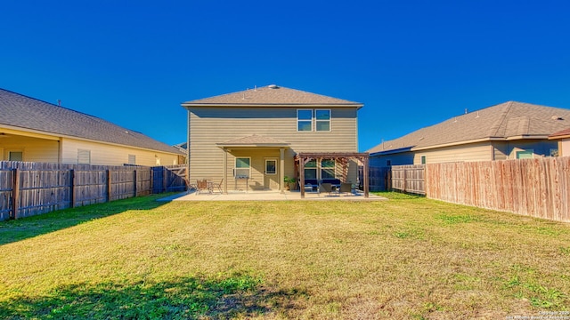 back of house featuring a lawn and a patio area