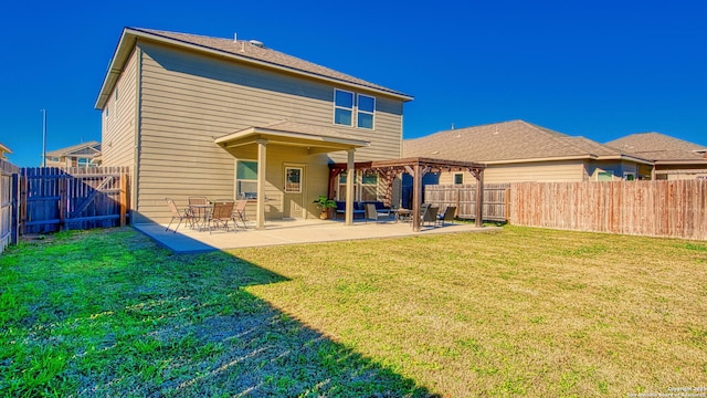 rear view of property with a patio and a lawn