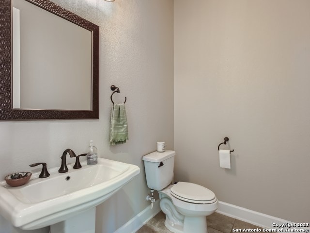 bathroom with tile patterned floors, sink, and toilet