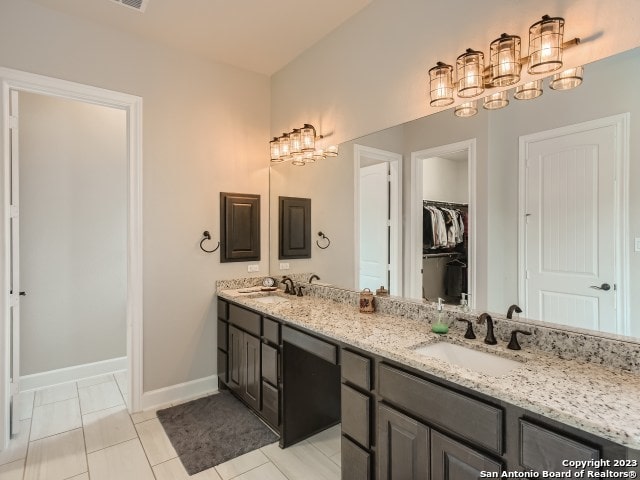 bathroom featuring tile patterned flooring and vanity