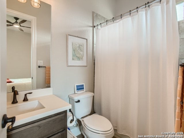 bathroom with ceiling fan, vanity, and toilet