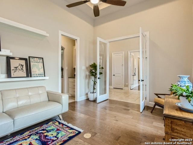 living room with french doors, light hardwood / wood-style flooring, and ceiling fan