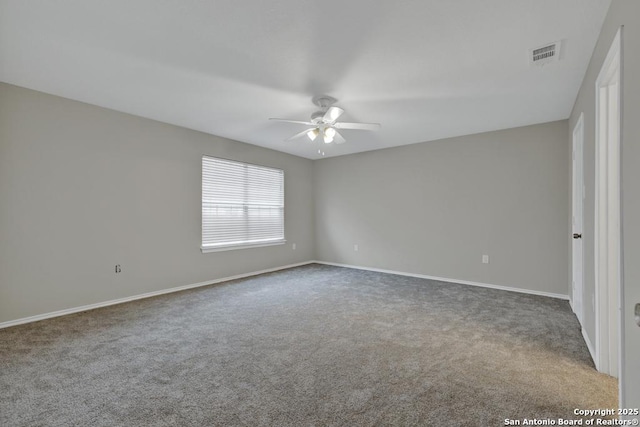 carpeted spare room featuring ceiling fan