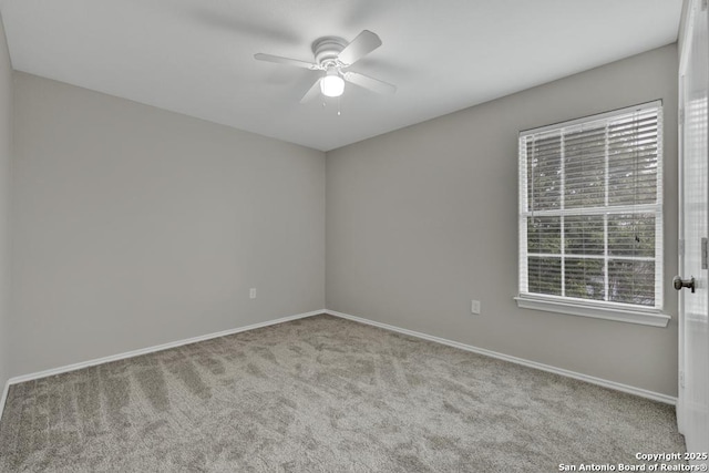 carpeted empty room with ceiling fan