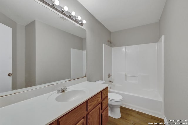 full bathroom featuring wood-type flooring, vanity, toilet, and shower / tub combination