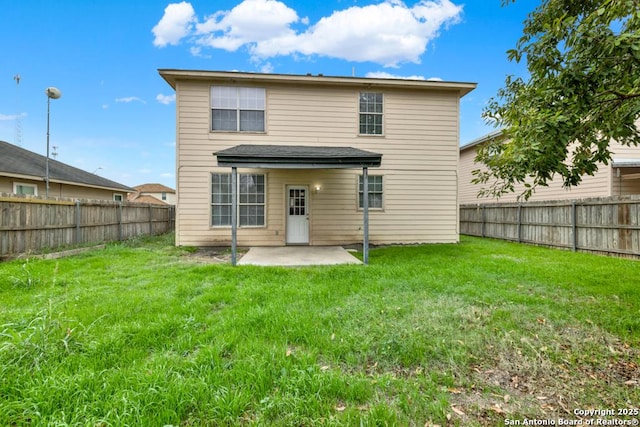 rear view of house with a lawn and a patio