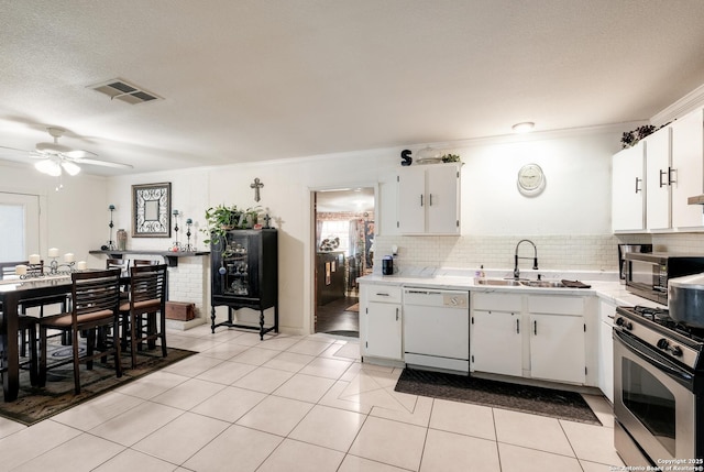 kitchen with white cabinetry, sink, dishwasher, and stainless steel range with gas stovetop