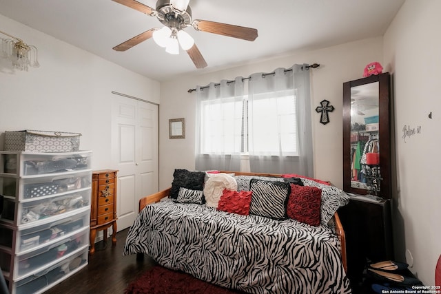 bedroom with a closet, ceiling fan, and dark hardwood / wood-style flooring