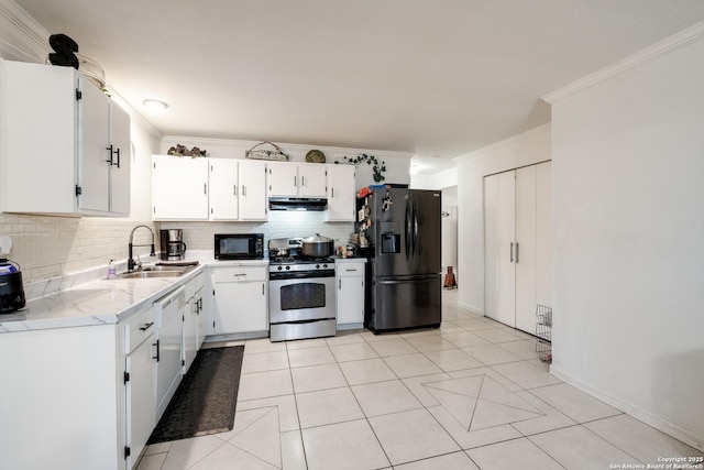 kitchen featuring backsplash, sink, fridge with ice dispenser, stainless steel gas stove, and white cabinetry