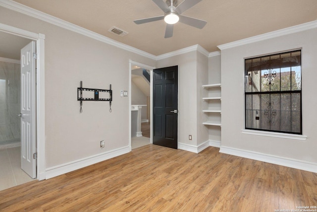 unfurnished bedroom with ceiling fan, crown molding, light hardwood / wood-style floors, and ensuite bath