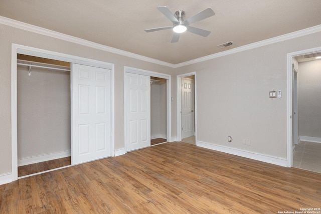 unfurnished bedroom with wood-type flooring, ceiling fan, and crown molding