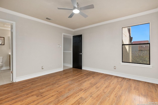 unfurnished bedroom with ceiling fan, crown molding, light hardwood / wood-style flooring, and ensuite bath