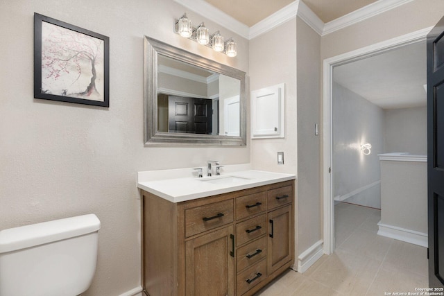 bathroom featuring toilet, crown molding, and vanity