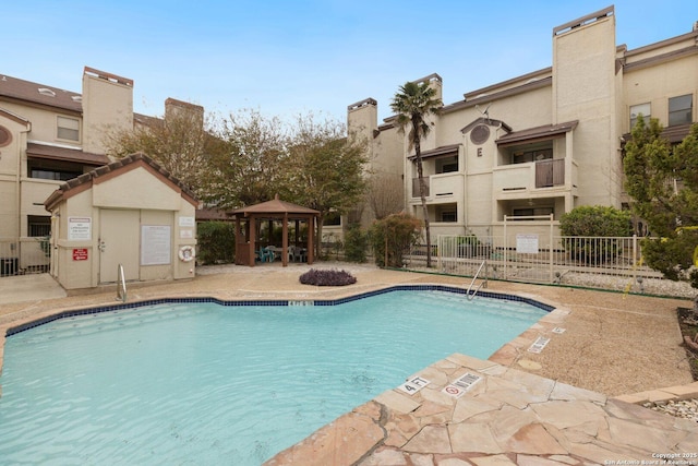 view of swimming pool with a gazebo and cooling unit