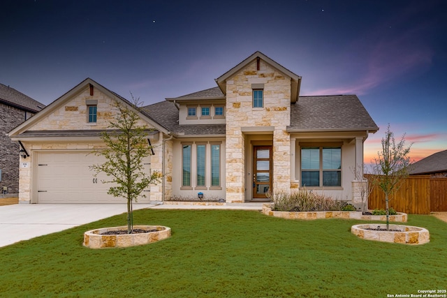 view of front of property featuring a garage and a lawn