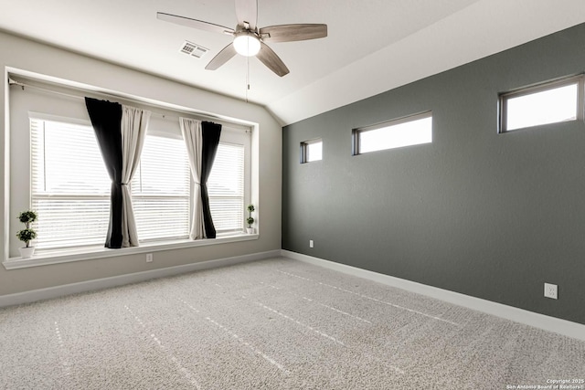 carpeted empty room with ceiling fan and lofted ceiling