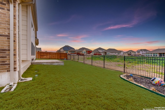 view of yard at dusk