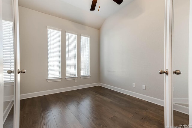 empty room featuring french doors, dark wood-type flooring, ceiling fan, and lofted ceiling