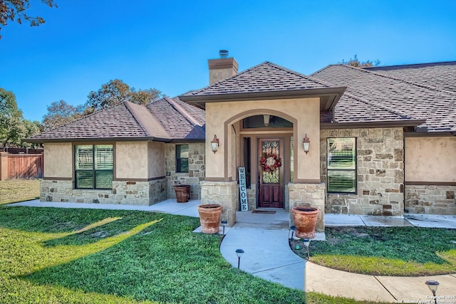 property entrance with a yard