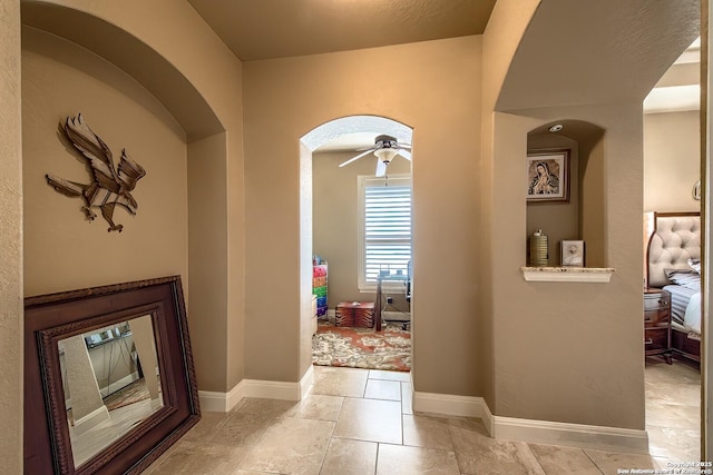 hall featuring light tile patterned flooring