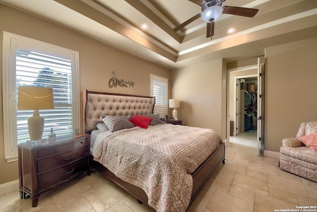 bedroom featuring a raised ceiling, ceiling fan, and crown molding