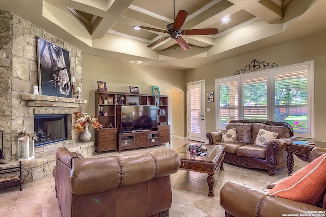 living room featuring a towering ceiling, coffered ceiling, ceiling fan, beam ceiling, and a stone fireplace