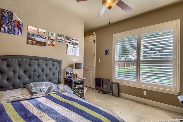 tiled bedroom featuring ceiling fan