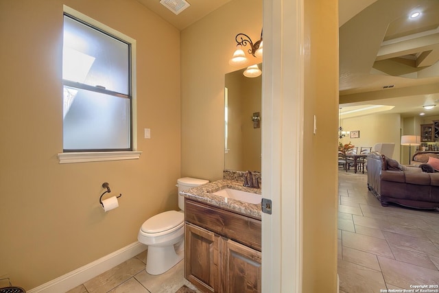 bathroom featuring tile patterned flooring, vanity, and toilet