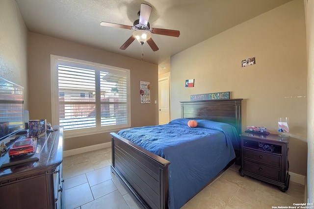 bedroom with a textured ceiling, ceiling fan, and light tile patterned flooring