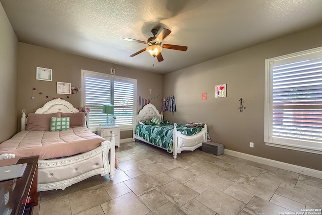 bedroom featuring a textured ceiling and ceiling fan