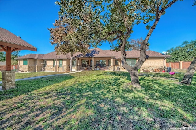 rear view of house with a lawn