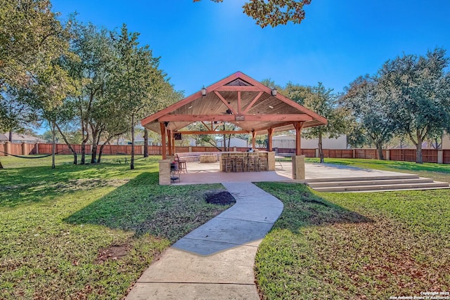 view of community with a gazebo, a yard, and an outdoor bar