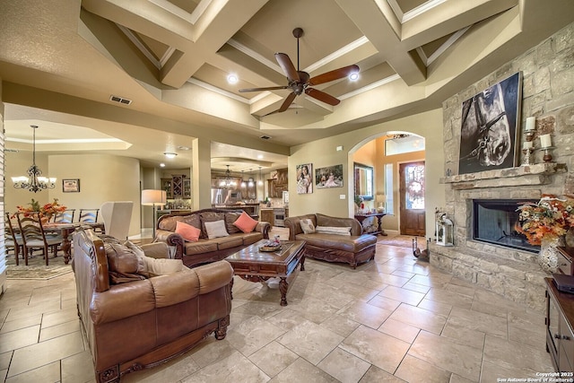 living room with beamed ceiling, ceiling fan with notable chandelier, and coffered ceiling