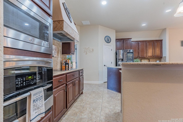 kitchen with light stone countertops, stainless steel appliances, a kitchen island, ventilation hood, and light tile patterned flooring