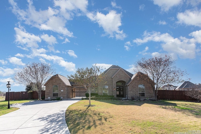 view of front of home with a front yard and a garage