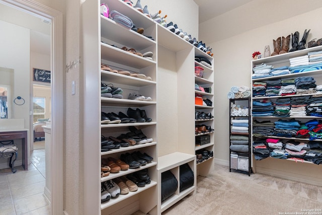 walk in closet featuring light carpet