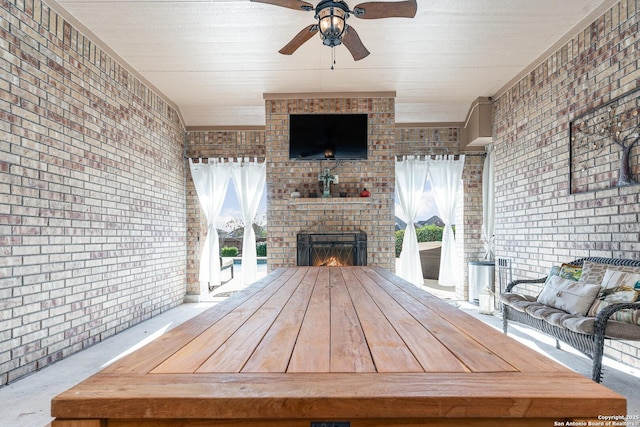 view of patio / terrace with ceiling fan and an outdoor brick fireplace