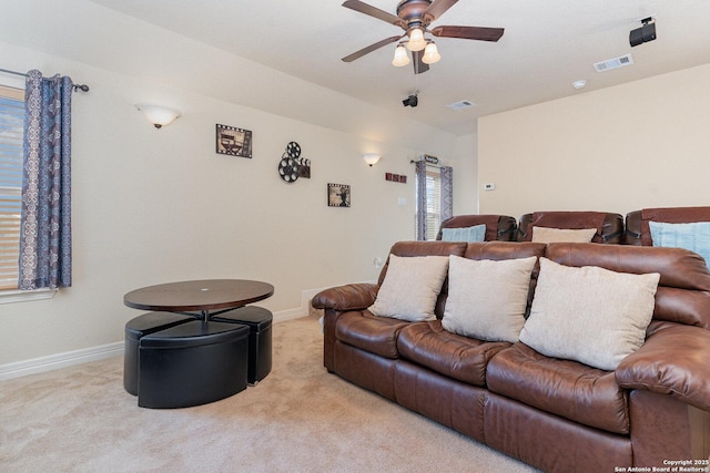 carpeted cinema featuring ceiling fan