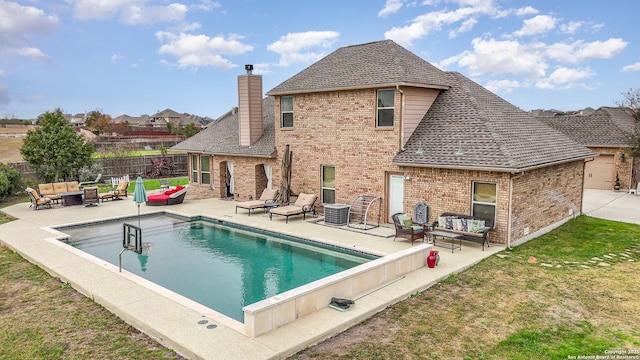 back of property featuring outdoor lounge area, a fenced in pool, and a patio