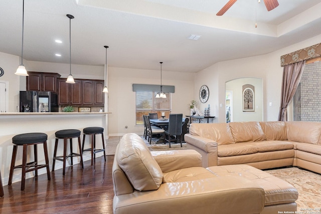 living room featuring ceiling fan and dark hardwood / wood-style flooring