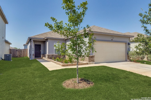 view of front of house featuring cooling unit, a garage, and a front lawn