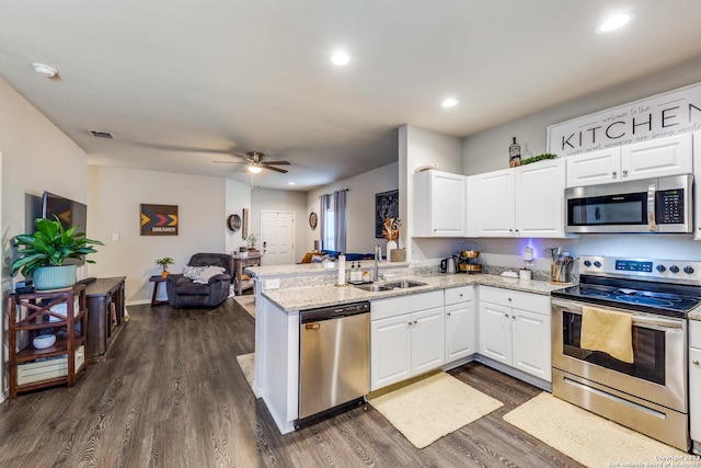 kitchen featuring kitchen peninsula, white cabinetry, sink, and stainless steel appliances