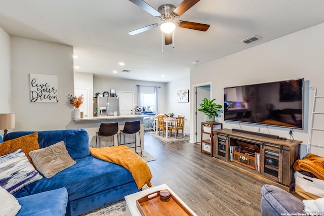 living room with hardwood / wood-style floors and ceiling fan