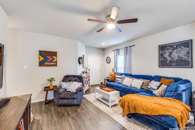 living room with ceiling fan and dark hardwood / wood-style flooring