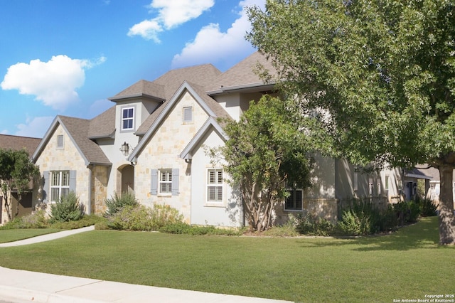 604 Hannahs Run, New Braunfels, TX 78130 - french country inspired facade with stone siding, a front yard, roof with shingles, and stucco siding
