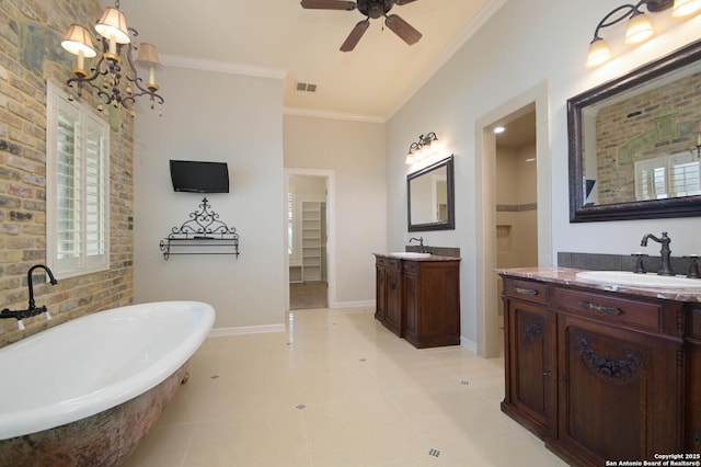 604 Hannahs Run, New Braunfels, TX 78130 - bathroom with a soaking tub, two vanities, crown molding, a ceiling fan, and baseboards