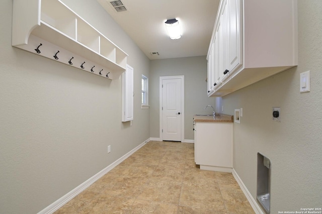 604 Hannahs Run, New Braunfels, TX 78130 - laundry room featuring hookup for an electric dryer, cabinet space, baseboards, and hookup for a washing machine