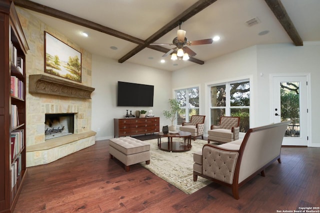 604 Hannahs Run, New Braunfels, TX 78130 - living area with beamed ceiling, a ceiling fan, healthy amount of natural light, dark wood finished floors, and a fireplace