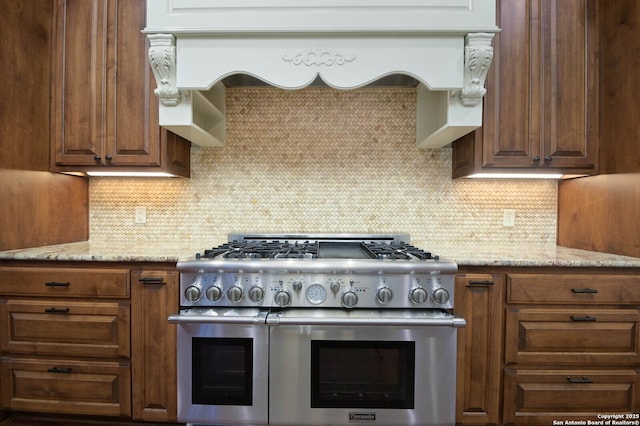 604 Hannahs Run, New Braunfels, TX 78130 - kitchen featuring double oven range, tasteful backsplash, and light stone counters